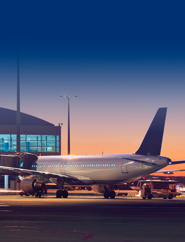 Exterior view of passenger plane sitting at gate of airport